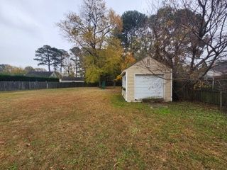 A large white house with black shutters and a gray roof