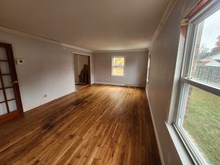 A large white house with black shutters and a gray roof
