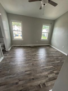 A large white house with black shutters and a gray roof