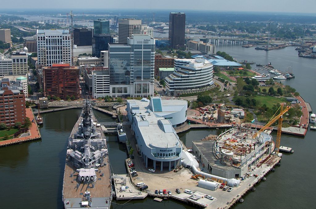 An aerial view of a city with two ships in the water