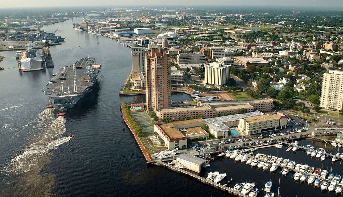 An aerial view of a city with two ships in the water