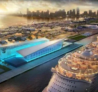 Cruise ship docked at a modern terminal, port with cityscape in the distance, bathed in morning light.