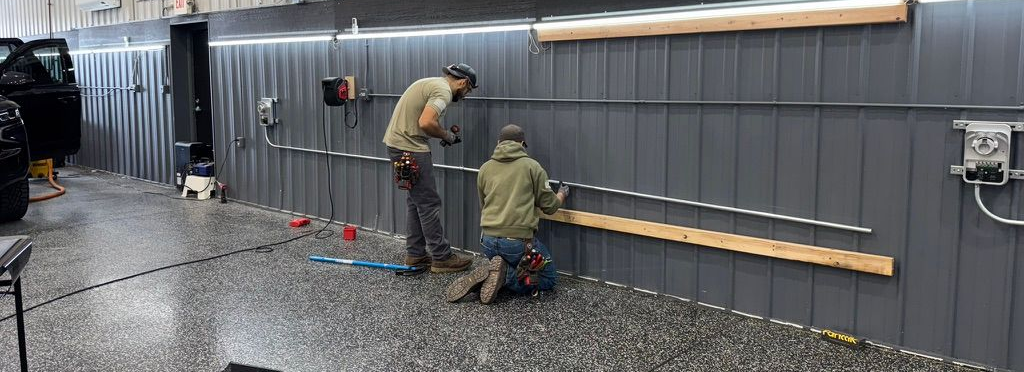 Two Employees installing two EV Chargers