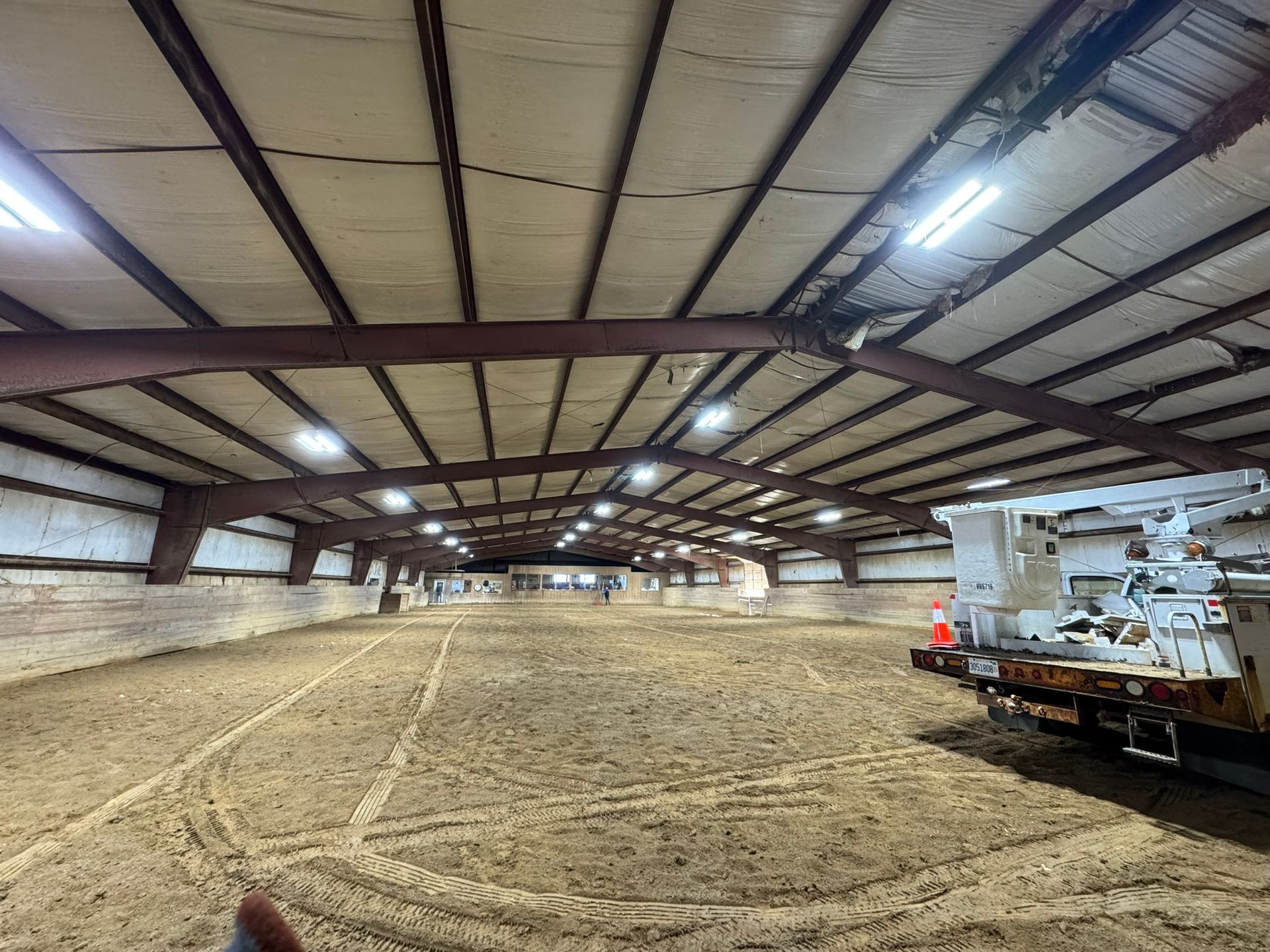 A large indoor arena with a lot of lights on the ceiling.