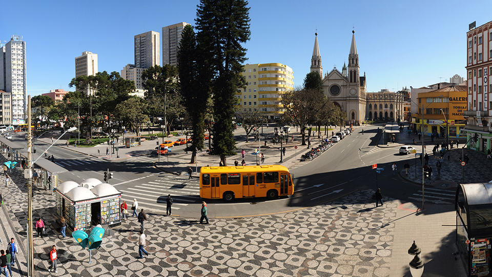 A yellow bus is driving down a city street
