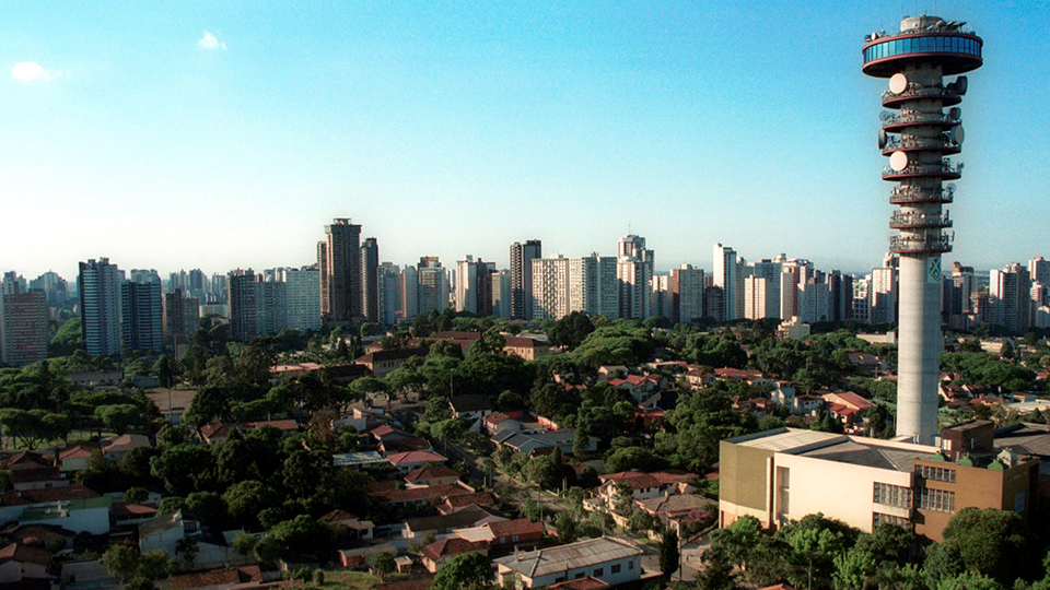 An aerial view of a city with a tower in the middle