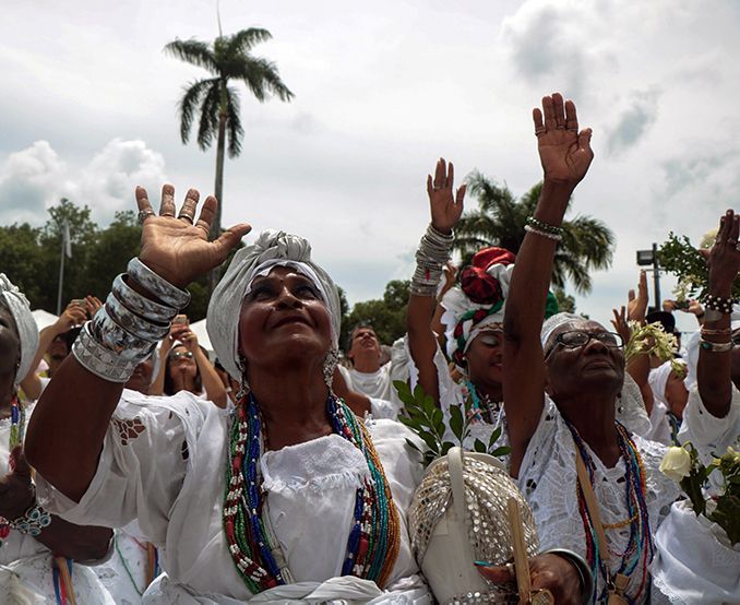 A group of people are raising their hands in the air