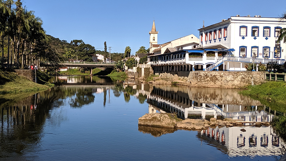 A bridge over a river with buildings in the background