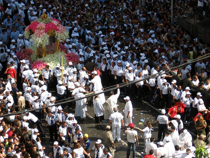 A large crowd of people are gathered around a float