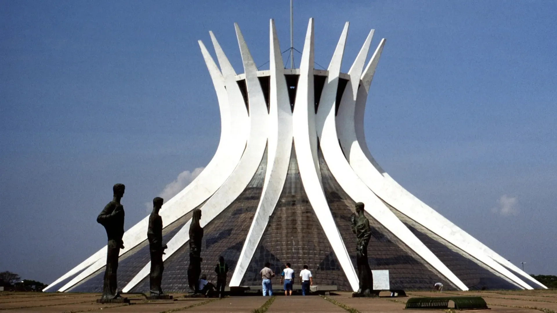 A group of people standing in front of a large white building