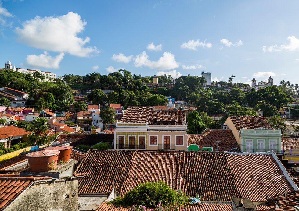 An aerial view of a city with a lot of houses and roofs.