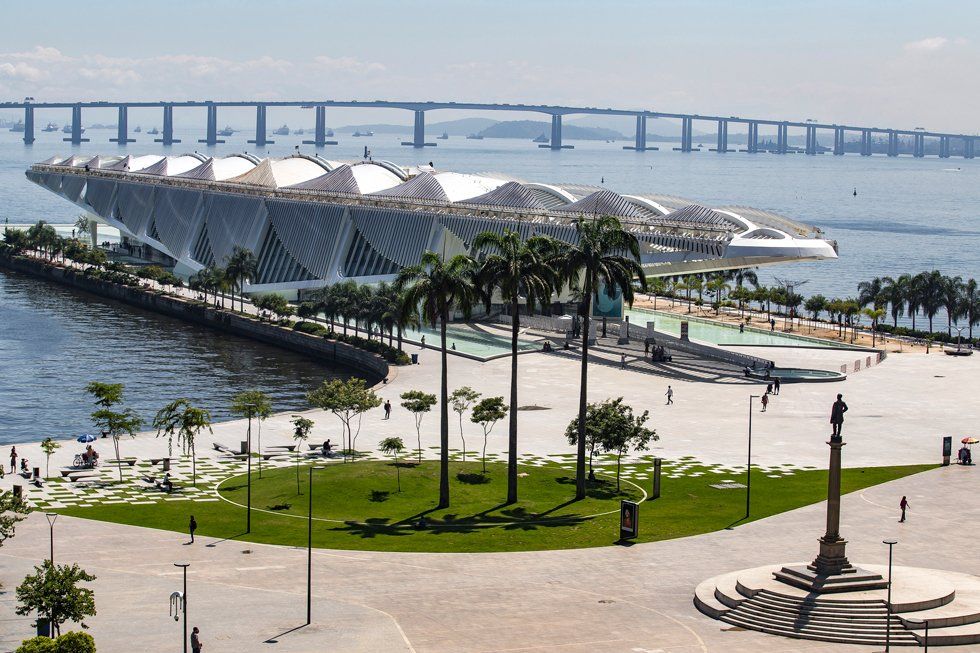 An aerial view of a city with a bridge in the background