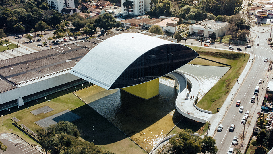 An aerial view of a large building with a curved roof