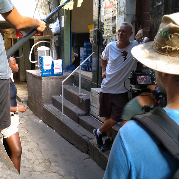 An old man talks to a camera crew