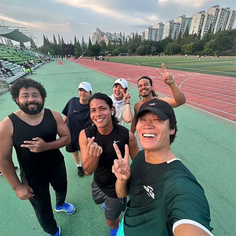 A group of people posing for a picture on a track