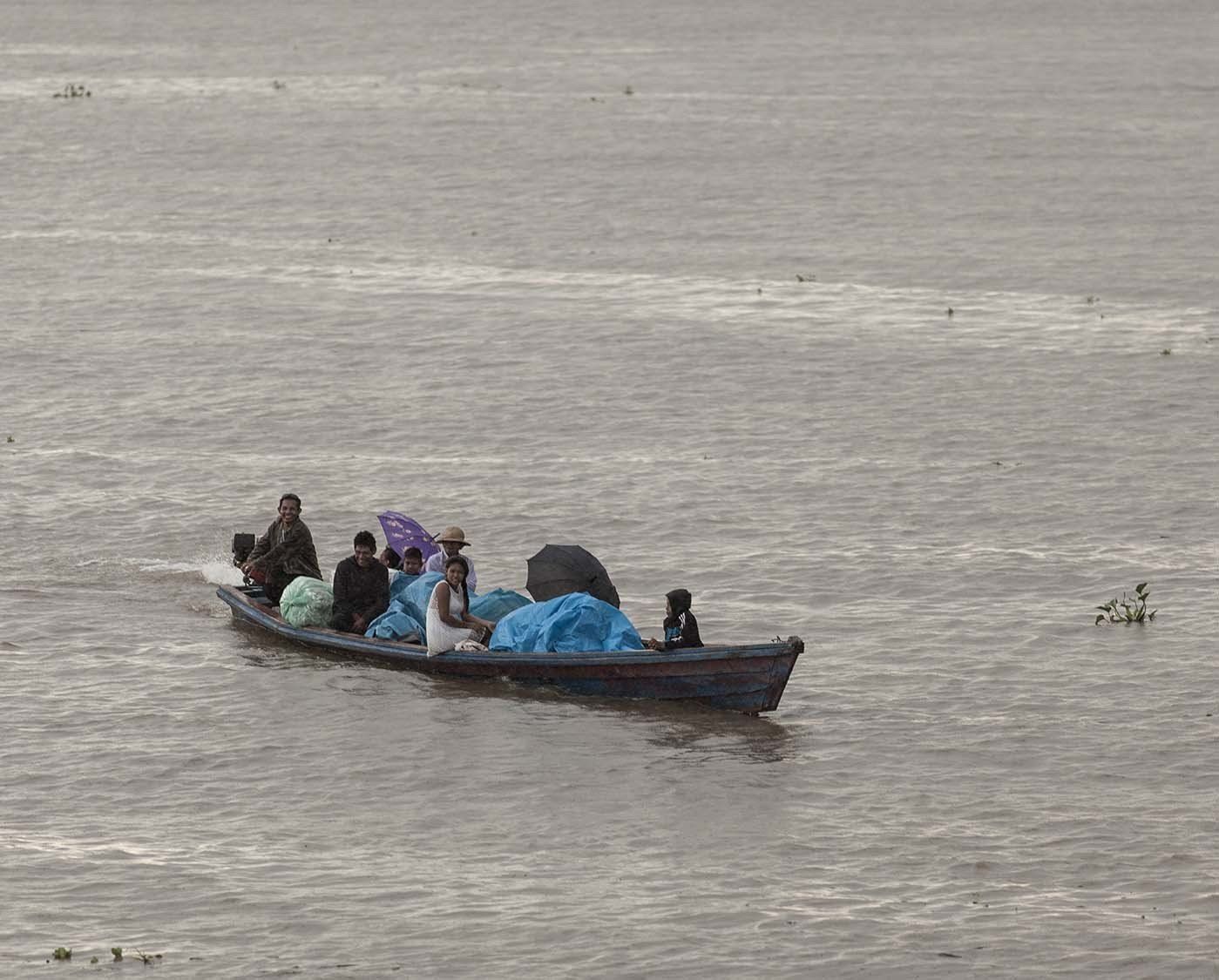 A group of people are riding in a boat on a river.