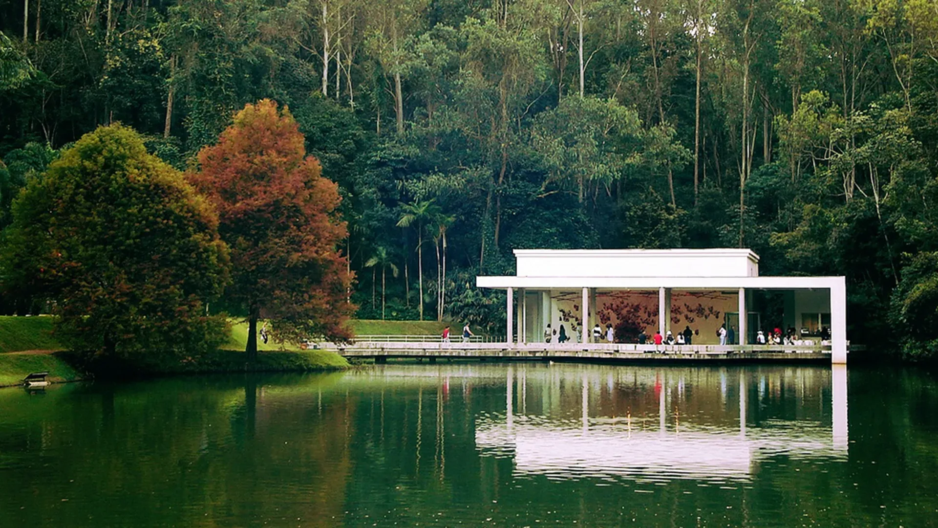 A house sits on a dock in the middle of a lake