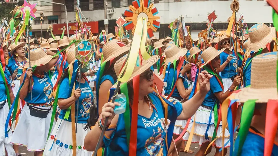 People with straw hats decorated with colorful ribbons attend the Pavulagem Festival in Belém