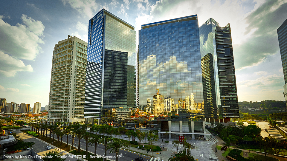 A cityscape with a lot of tall buildings and palm trees