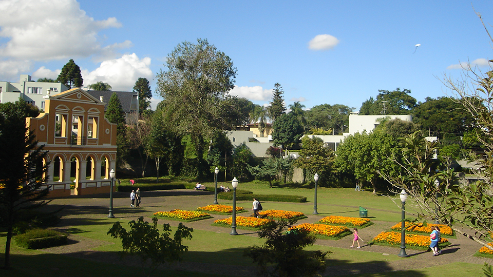 A large building sits in the middle of a park