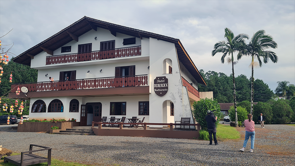 A large white house with a palm tree in front of it