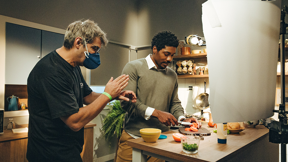 A panoramic view on a coffee farm in rural Brazil Two men are standing next to each other in a kitchen preparing food.
