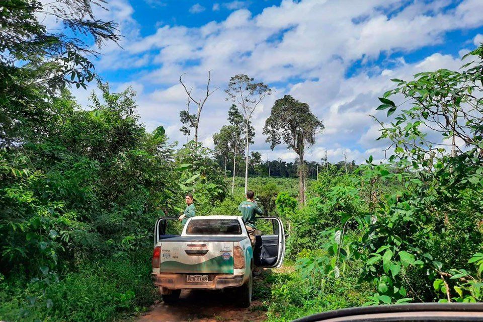 A truck of the state combat force parked on a dirt road within a field