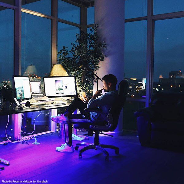 Remote post-production A man is sitting in front of a computer at night