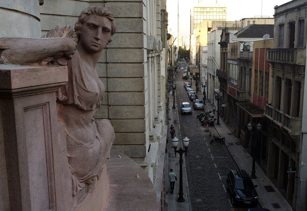 A stoned street with mild traffic in the city of Santos