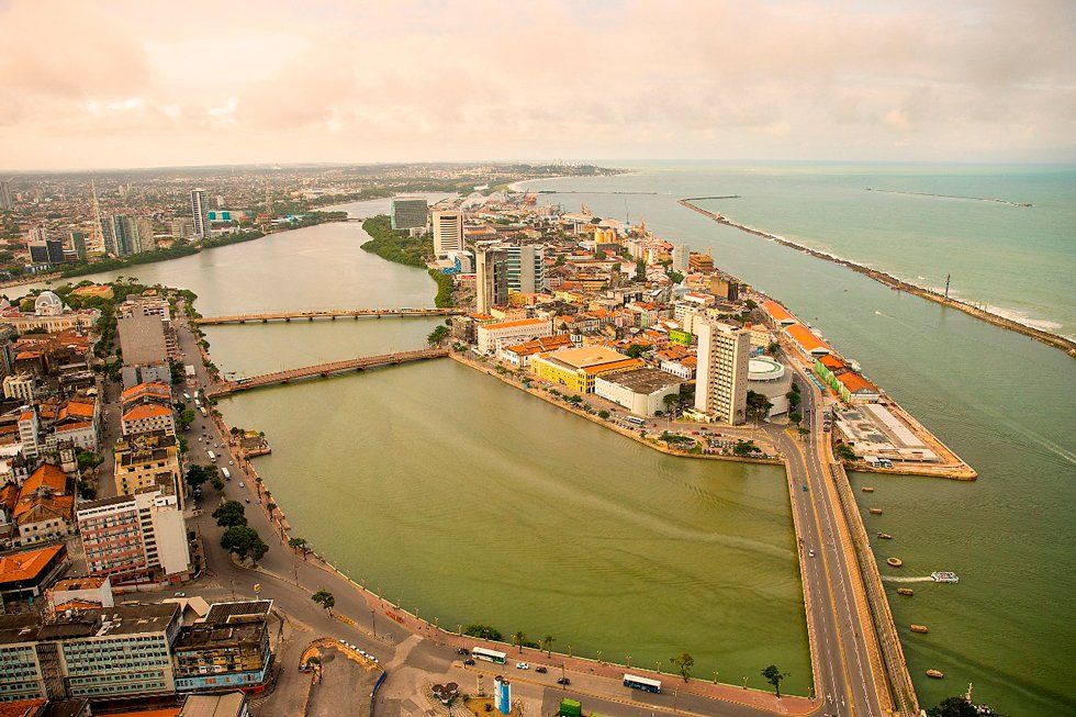 An aerial view of a city with a bridge over a body of water