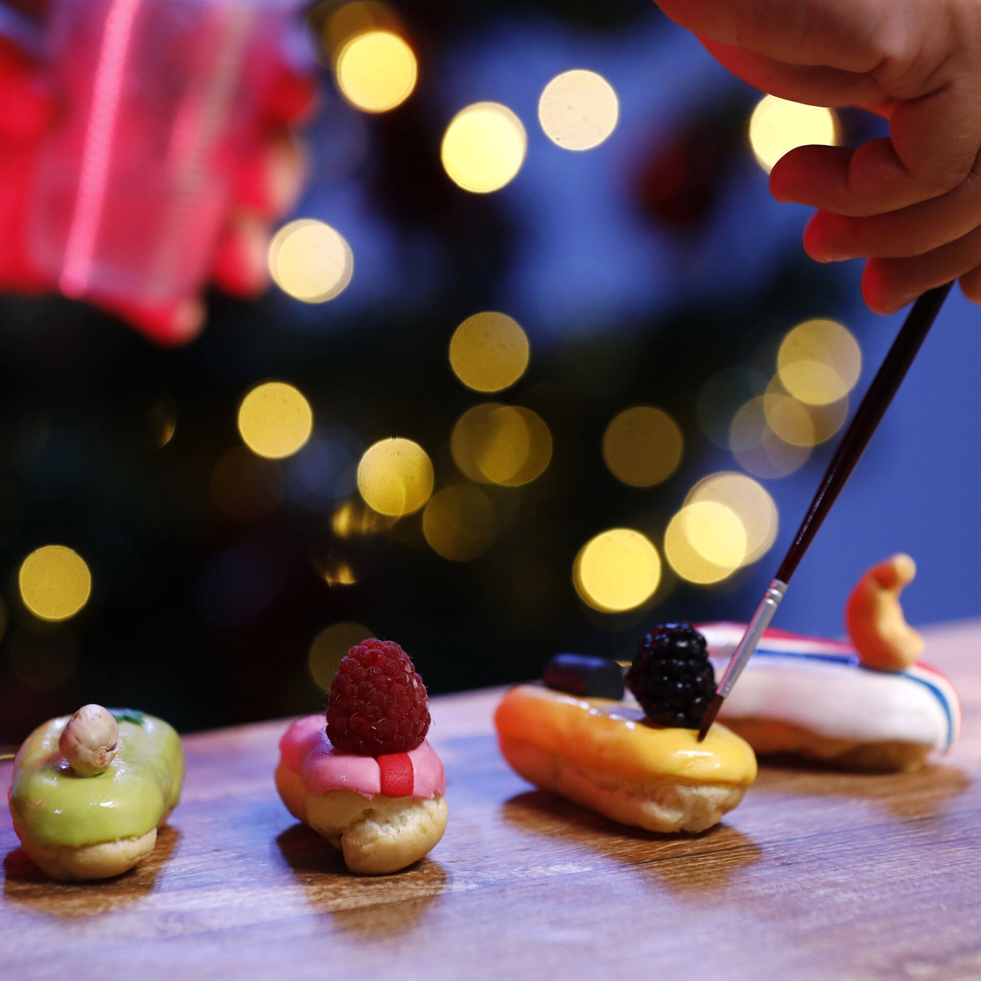 A person is decorating a dessert with a brush