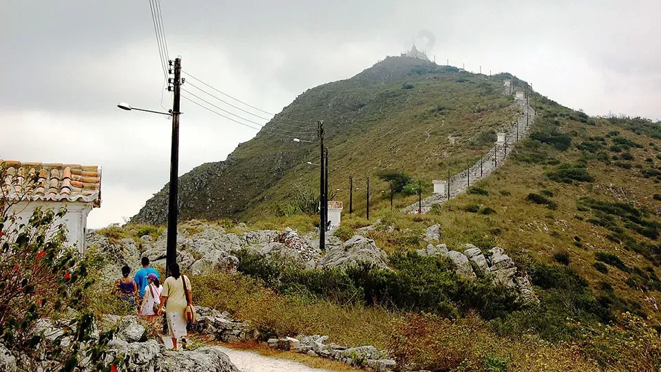 A group of people are walking up a hill.