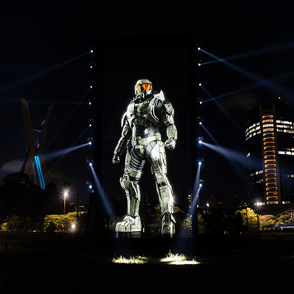 The Story Productions crew films on location in rural Brazil A statue of a soldier is projected on a wall at night