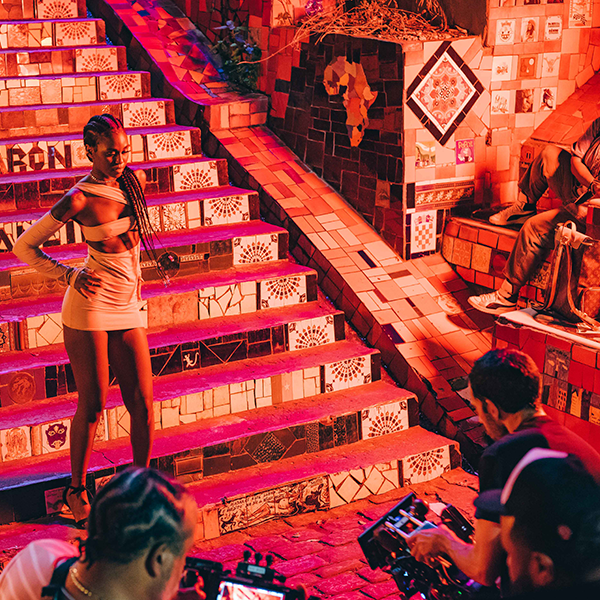 A woman in a white skirt is standing on a set of stairs.