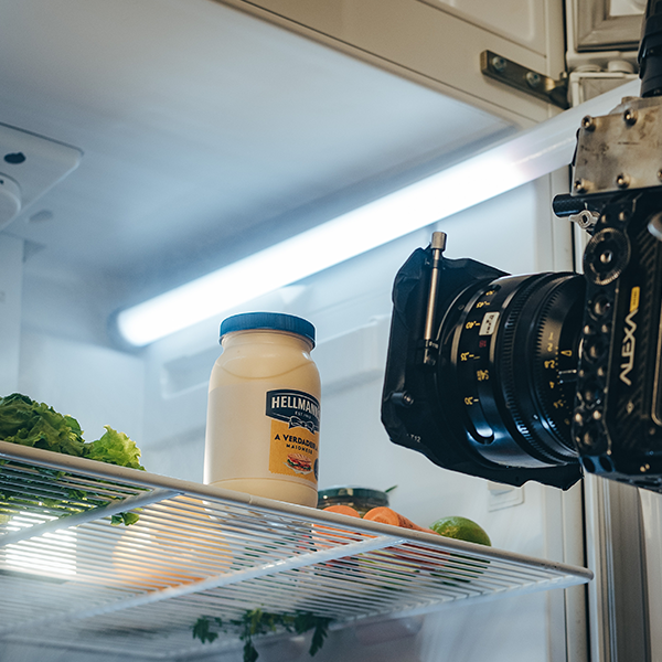 On location at a coffee farm in rural Brazil A bottle of hellman 's mayonnaise sits on a shelf next to a camera