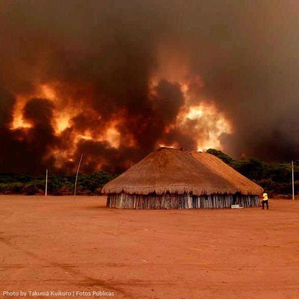 A burning village in Xingú, Brazil A burning village with a burning forrest on the background