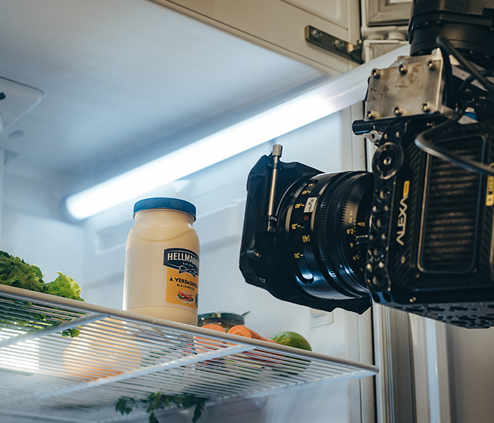 A bottle of philadelphia mayonnaise sits on a shelf in a refrigerator