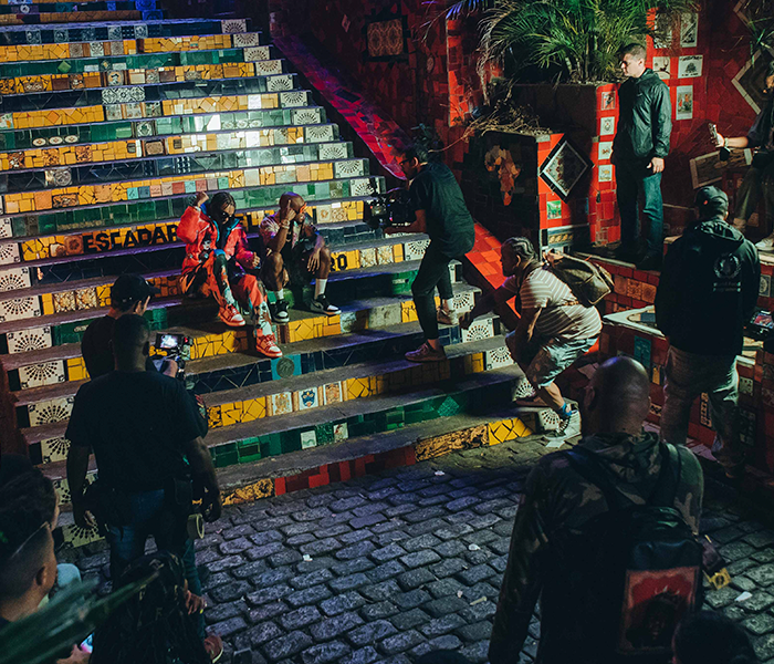 A group of people are sitting on a set of stairs.