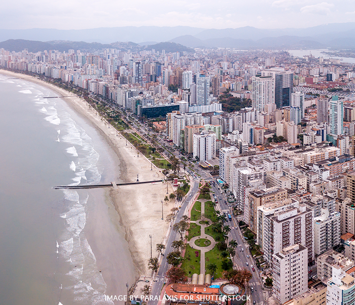 An aerial view of a city with buildings and a beach.
