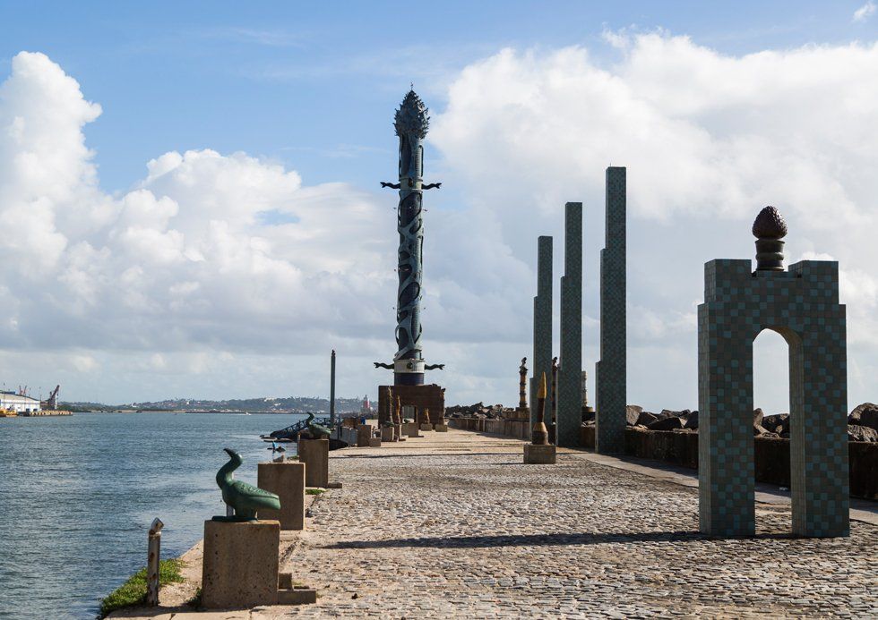 A statue of an elephant is on the side of a pier