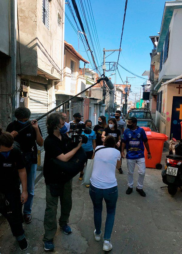 A group of people are walking down a narrow street.
