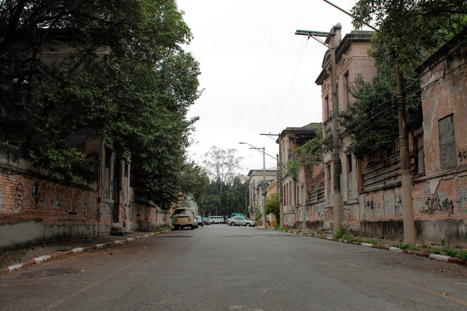 An empty street with cars parked on the side of it