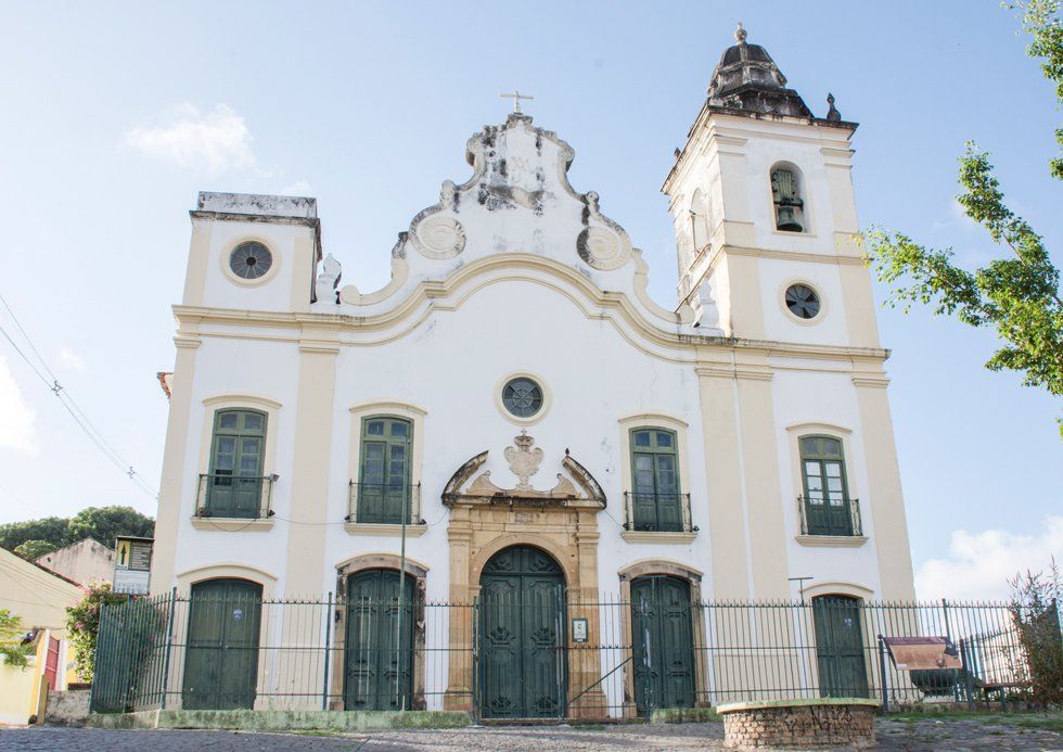A large white and gold church with a bell tower