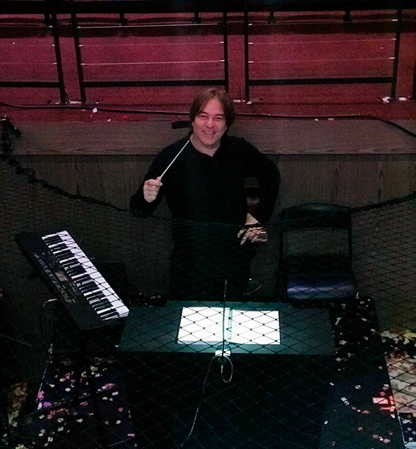 Musician Rafael Righini stands smiling