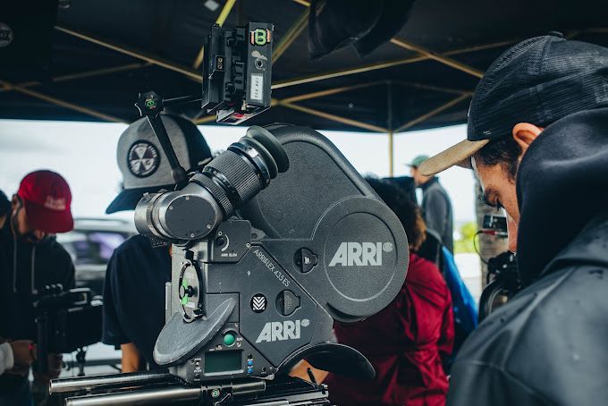 A man is standing in front of an arri camera.