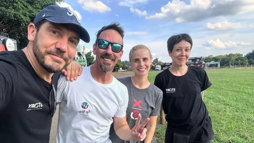 A group of people are posing for a picture in a field.