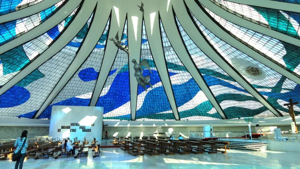 The inside of a church with a stained glass dome
