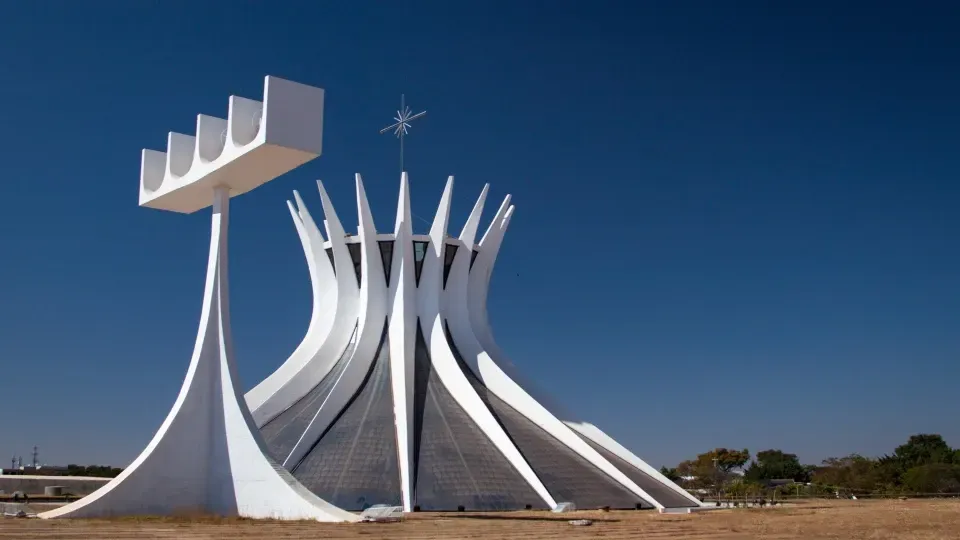 A large white building with a cross on top of it