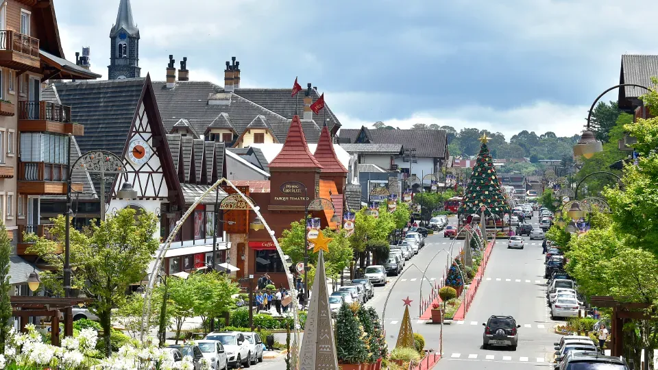 A city street with a lot of cars driving down it.
