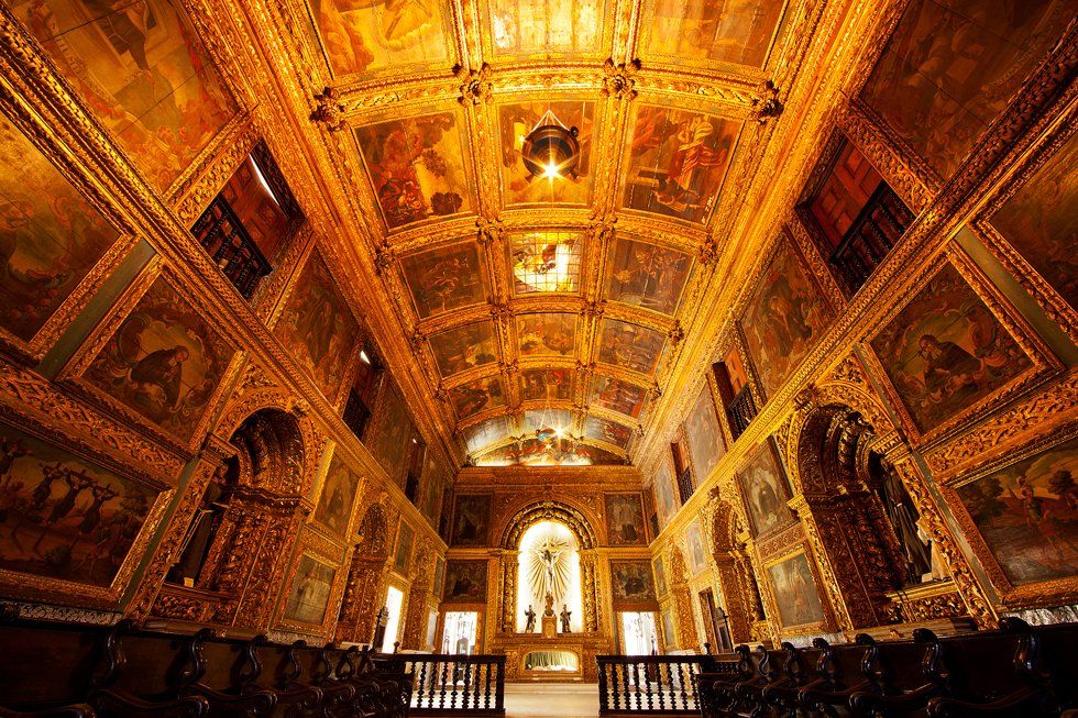 A church with a lot of paintings on the walls and ceiling